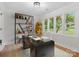 This bright office includes a large modern desk, built-in shelving, and natural light from three large windows at 981 Meadowlark Dr, Rock Hill, SC 29732