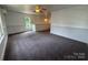Bright and airy bonus room with soft carpet, wainscoting detail, and modern fan at 1019 Valley St, Kannapolis, NC 28081