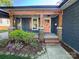 Inviting front porch with stylish accents, stone supports, and colorful landscaping at 1019 Valley St, Kannapolis, NC 28081