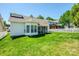 Well-maintained backyard with green grass, white picket fence, and screened-in patio area at 1027 Feather Oak Ln, Matthews, NC 28104