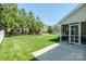 Spacious backyard with lush lawn, mature trees, and screened-in porch, perfect for entertaining at 1027 Feather Oak Ln, Matthews, NC 28104