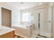 Bathroom showcasing a soaking tub, a glass enclosed shower, and a tiled floor at 1027 Feather Oak Ln, Matthews, NC 28104