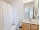 Bright, clean bathroom featuring a shower with curtain, and modern sink at 1027 Feather Oak Ln, Matthews, NC 28104