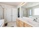 Bathroom featuring a double sink vanity, a large mirror, and a separate tub and shower at 1027 Feather Oak Ln, Matthews, NC 28104