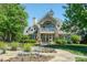 Elegant clubhouse featuring manicured landscaping, stone accents, and a charming entrance at 1027 Feather Oak Ln, Matthews, NC 28104