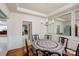 Cozy dining room featuring hardwood floors, chair rail molding, and stylish chandelier at 1027 Feather Oak Ln, Matthews, NC 28104