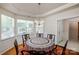 Bright dining room with hardwood floors, a bay window, and an elegant chandelier at 1027 Feather Oak Ln, Matthews, NC 28104