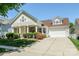 Charming two-story home featuring a well-maintained lawn, inviting front porch and attached two-car garage at 1027 Feather Oak Ln, Matthews, NC 28104