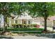 Inviting two-story home framed by mature trees and lush landscaping, with a well-manicured lawn at 1027 Feather Oak Ln, Matthews, NC 28104
