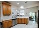 Open concept kitchen with stainless steel dishwasher, light oak cabinetry, and bright white countertop at 1027 Feather Oak Ln, Matthews, NC 28104