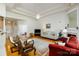 Bright and open living room featuring tray ceilings, a fireplace, and hardwood flooring at 1027 Feather Oak Ln, Matthews, NC 28104