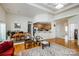 Open-concept living area with hardwood floors connecting to the dining and kitchen spaces at 1027 Feather Oak Ln, Matthews, NC 28104