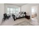 Comfortable main bedroom featuring a bay window, plush carpet, and en-suite bathroom at 1027 Feather Oak Ln, Matthews, NC 28104
