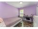 This bedroom has a bed, desk, hardwood floors, and is painted purple at 11224 Amber Glen Dr, Charlotte, NC 28269
