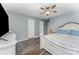 This is a primary bedroom with a ceiling fan, hard wood floors, and base board trim at 11224 Amber Glen Dr, Charlotte, NC 28269