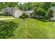 Charming single-story home with an attached garage, lush lawn, and mature landscaping at 11224 Amber Glen Dr, Charlotte, NC 28269
