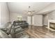 Cozy living room featuring a fireplace and comfortable leather seating with a ceiling fan at 11224 Amber Glen Dr, Charlotte, NC 28269