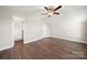 A spacious bedroom with hardwood floors, a ceiling fan, and multiple closets for storage at 11249 Island View Ln, Lancaster, SC 29720