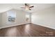 Bedroom featuring wood floors, a ceiling fan, and a window with views of the neighborhood at 11249 Island View Ln, Lancaster, SC 29720
