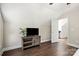 Cozy bonus room with wood-look flooring, a TV, and a doorway leading to another area at 11249 Island View Ln, Lancaster, SC 29720