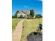 Beautiful exterior of a home with landscaped yard, long driveway and a blue sky at 11249 Island View Ln, Lancaster, SC 29720