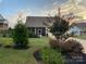 Well-manicured front yard with lush landscaping and a charming home facade at sunset at 11249 Island View Ln, Lancaster, SC 29720