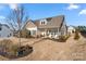 Charming home featuring a well-manicured lawn, inviting front porch with chairs, and tasteful landscaping at 11249 Island View Ln, Lancaster, SC 29720