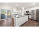 Bright kitchen featuring an island, stainless steel appliances, and access to a backyard patio at 11249 Island View Ln, Lancaster, SC 29720