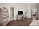 Stylish living area showcases a bathroom view, entertainment center, and wood-look flooring at 11249 Island View Ln, Lancaster, SC 29720