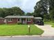 Quaint brick home with a well-manicured lawn and convenient carport at 1203 Pamela Dr, Shelby, NC 28150