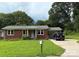 Charming brick home with well-maintained lawn, covered parking, and a welcoming front entrance at 1203 Pamela Dr, Shelby, NC 28150