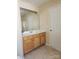 Classic bathroom featuring a wood vanity, ample mirror, and neutral tiled floors, exuding practical comfort at 121 Marcella Dr, Kings Mountain, NC 28086