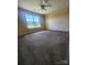 Bright bedroom boasts a ceiling fan, large window, and ample space, offering a comfortable retreat at 121 Marcella Dr, Kings Mountain, NC 28086