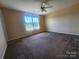 Bright bedroom boasts a ceiling fan, large window, and ample space, offering a comfortable retreat at 121 Marcella Dr, Kings Mountain, NC 28086
