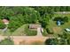 An aerial shot of the residence highlighting its landscaping, driveway and surrounding green trees at 130 Helen Dr, Statesville, NC 28625