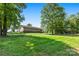 Expansive backyard featuring a lush green lawn and mature trees, perfect for outdoor activities at 130 Helen Dr, Statesville, NC 28625