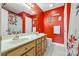 A full bathroom with double sinks, mirror, red walls and bathtub with shower at 130 Helen Dr, Statesville, NC 28625
