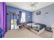 A bedroom with light blue walls, window with curtains, small desk and large mirror at 130 Helen Dr, Statesville, NC 28625