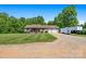 Front exterior view of a cozy home featuring a covered porch, a large driveway, and a two-car garage at 130 Helen Dr, Statesville, NC 28625