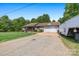 Ranch style home with a spacious driveway and attached two car garage and large front yard at 130 Helen Dr, Statesville, NC 28625