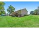 Exterior side view of a tan sided home with a walk out basement and back deck at 130 Helen Dr, Statesville, NC 28625