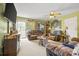 Cozy living room with comfortable leather furniture and a ceiling fan at 130 Helen Dr, Statesville, NC 28625