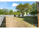 Expansive backyard with lush lawn, mature tree, and a charming white fence at 13502 Brandon Trail Dr, Charlotte, NC 28213