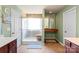 Clean bathroom featuring a glass shower, double sinks, cherry cabinets, and tile floors at 13502 Brandon Trail Dr, Charlotte, NC 28213