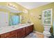 Comfortable bathroom with double vanity, cherry cabinets, and neutral paint at 13502 Brandon Trail Dr, Charlotte, NC 28213