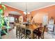 Open-concept dining room with seating for six and seamless transition to living area at 13502 Brandon Trail Dr, Charlotte, NC 28213