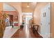 Inviting foyer with warm colors, hardwood floors, a staircase, and a view into the living area at 13502 Brandon Trail Dr, Charlotte, NC 28213