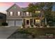 Charming two-story home with a well-manicured lawn, two-car garage, and stone accents at 13502 Brandon Trail Dr, Charlotte, NC 28213