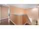 Well-lit hallway with hardwood floors and a staircase leading to the upper level at 13502 Brandon Trail Dr, Charlotte, NC 28213
