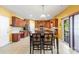 Well-lit kitchen with wooden cabinets, a center island, stainless steel appliances, and tiled floors at 13502 Brandon Trail Dr, Charlotte, NC 28213
